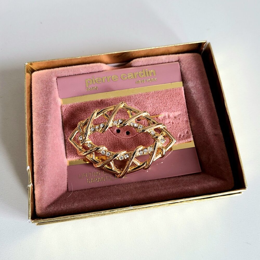 Vintage Pierre Cardin gold tone brooch with clear rhinestones in original box.
